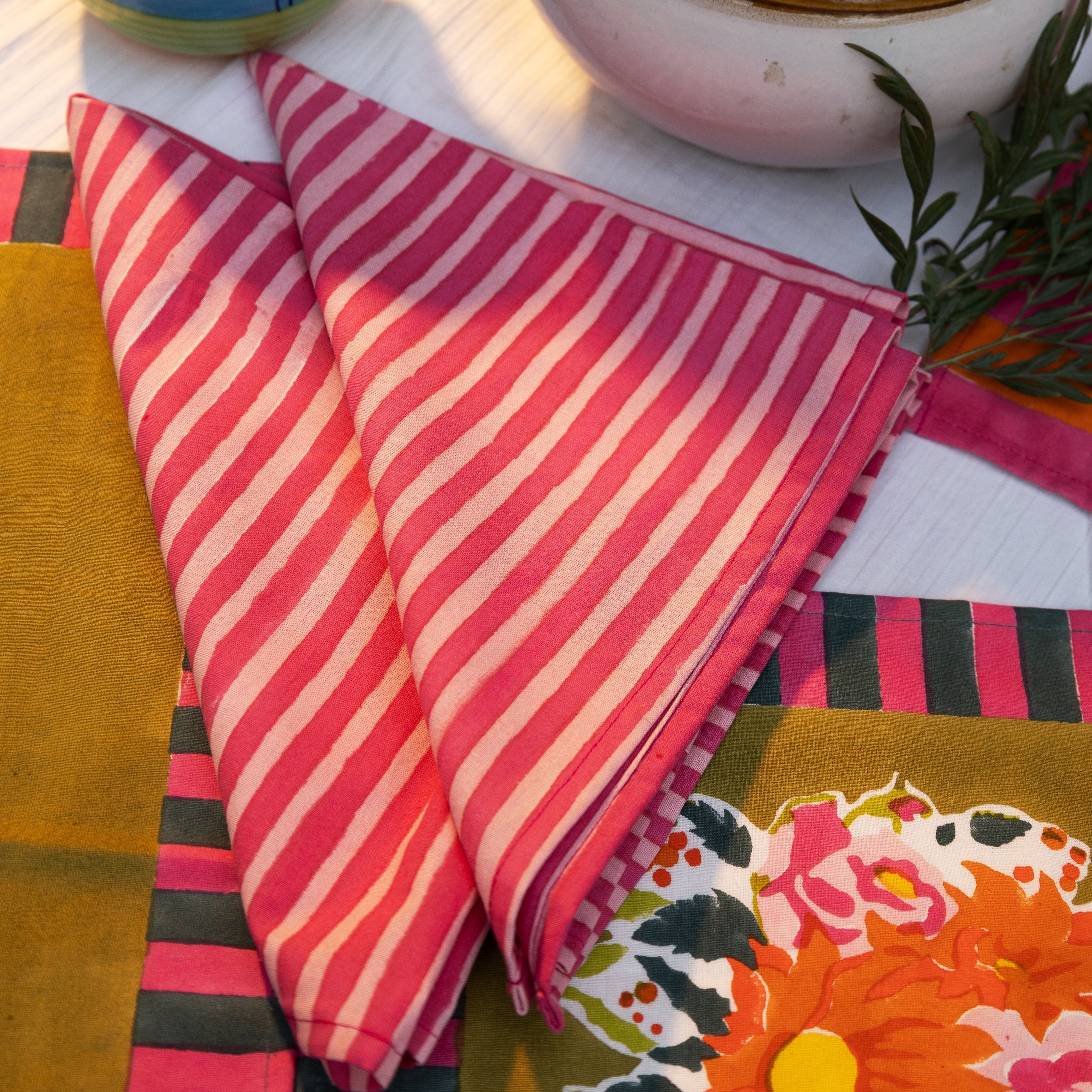 Gul pink and blue hand block-printed cotton table napkins (set of 4) by Thar, featuring striped bands handcrafted by artisan communities.