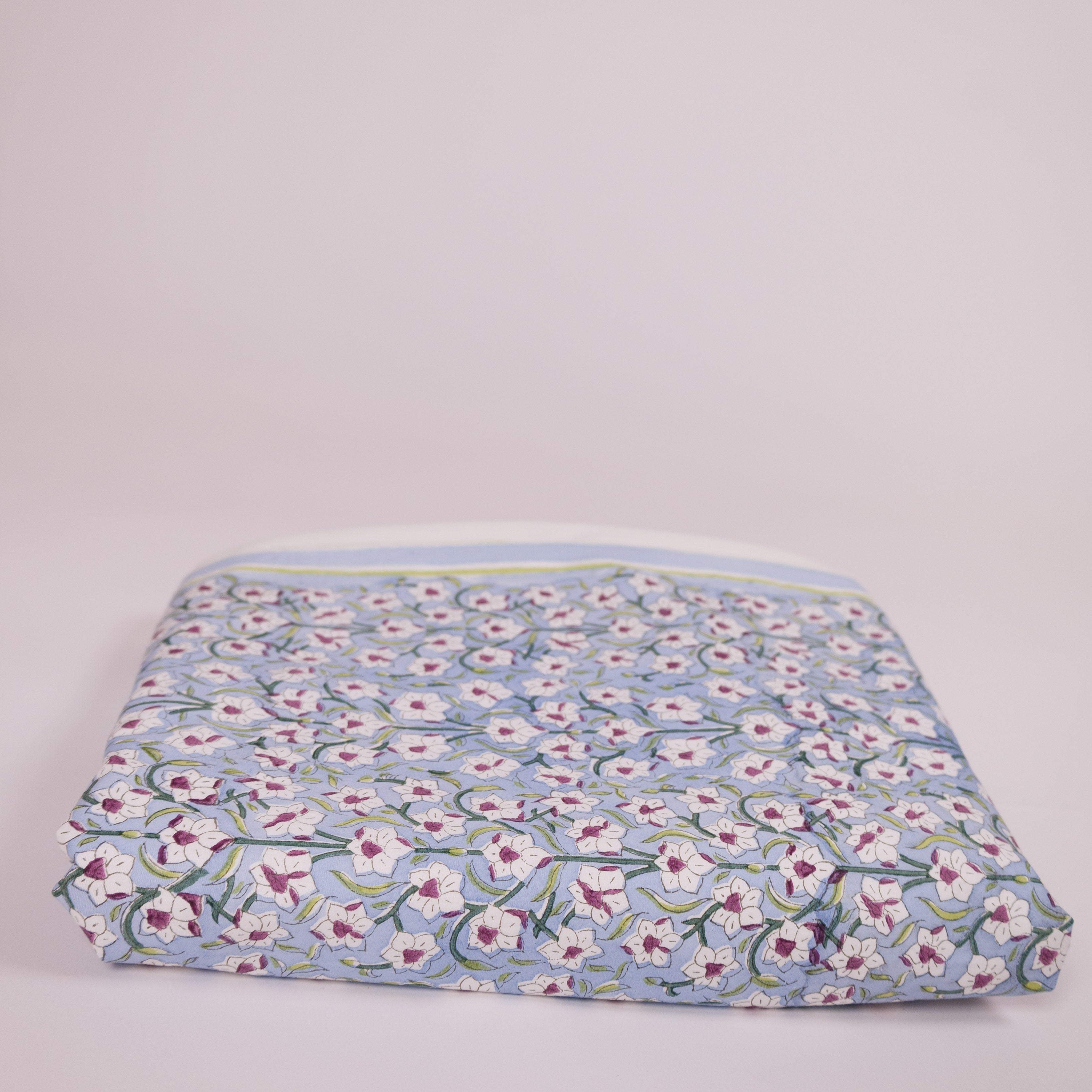 Nargis holiday gift set by Thar featuring a hand block-printed king duvet cover and matching pillow shams in a serene blue daffodil floral pattern.