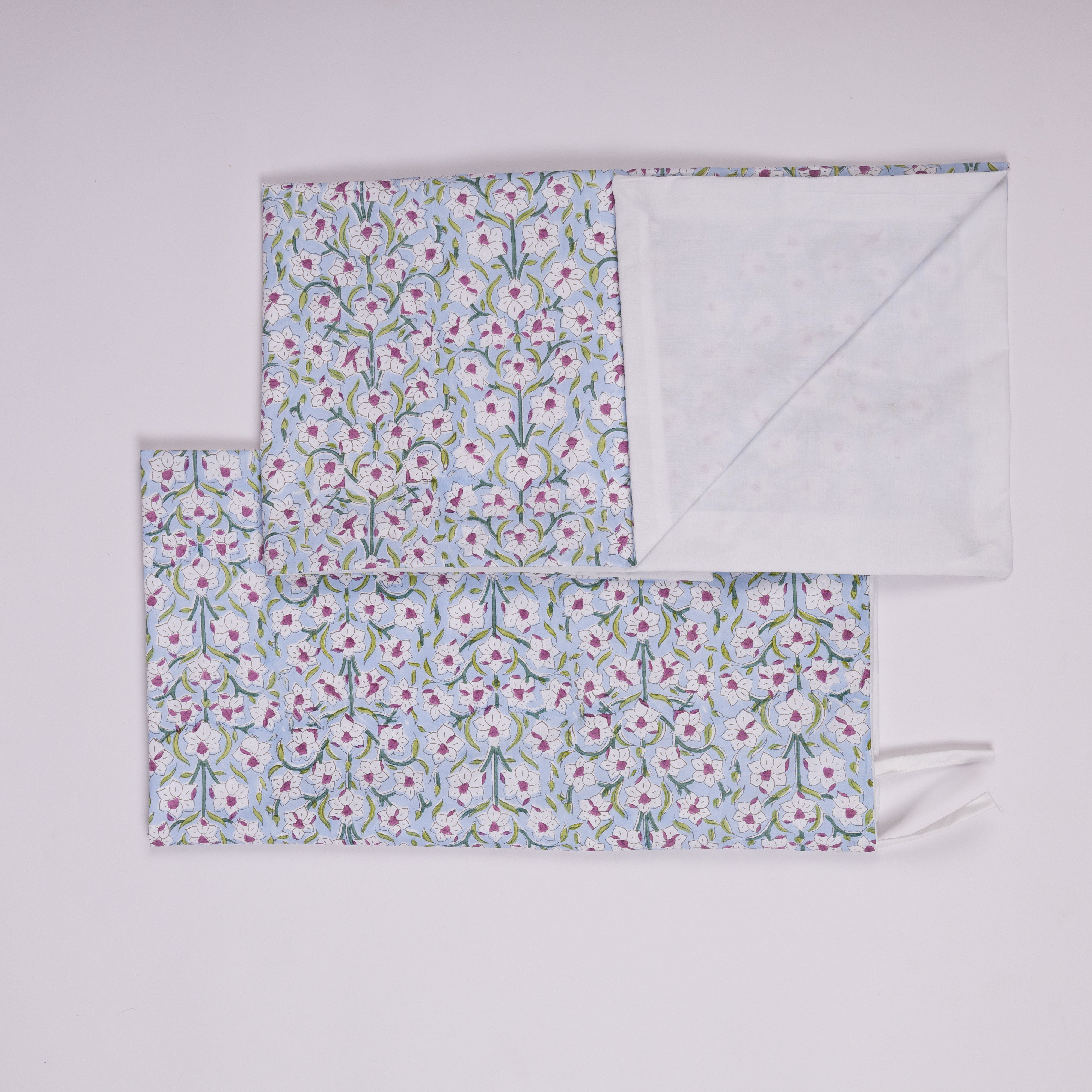 Reversible king duvet cover with a white daffodil print on a tranquil blue background and a crisp white percale reverse for a sophisticated bedroom look