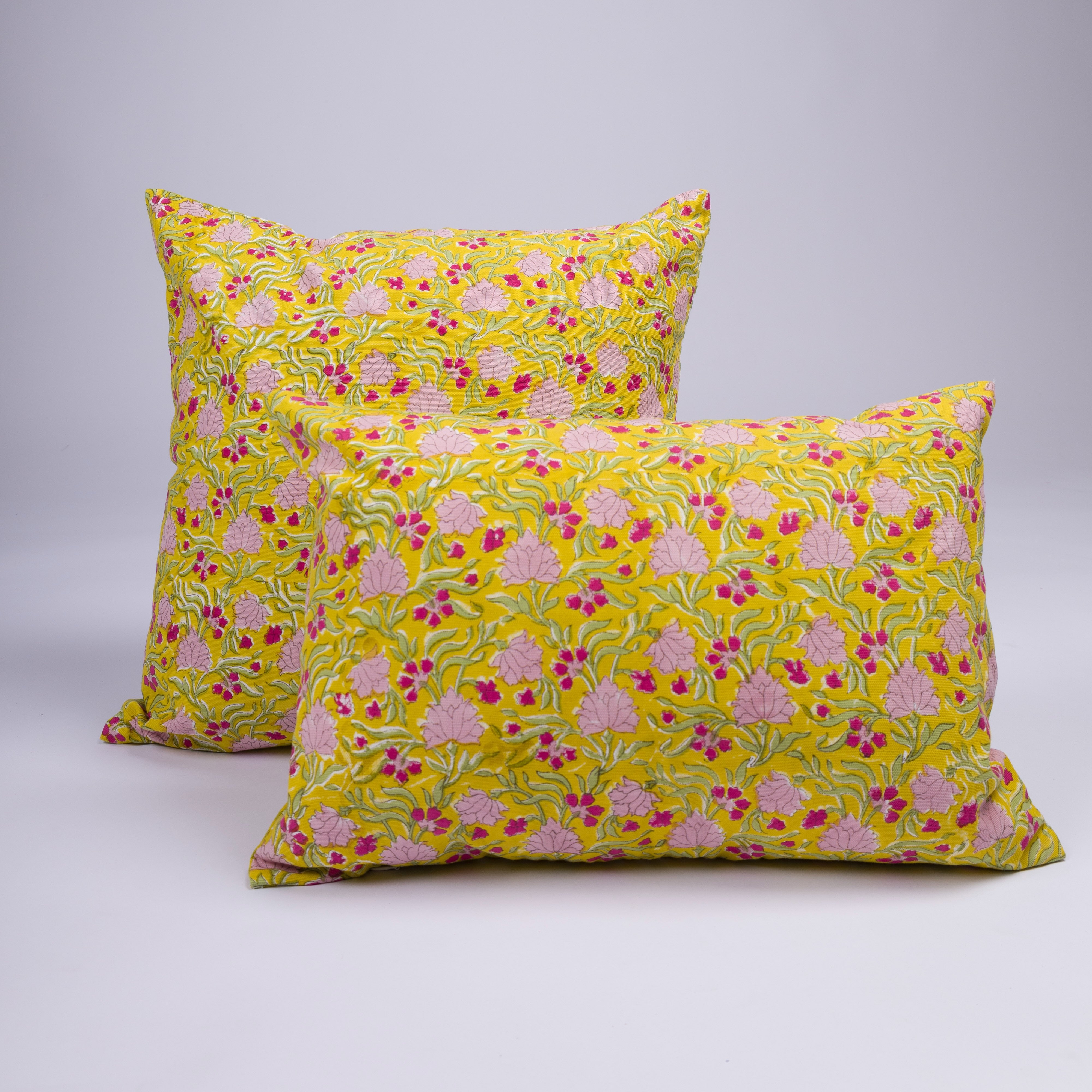Hand-printed lumbar and square pillowcases from the Jasmine collection for a curated bedscape.