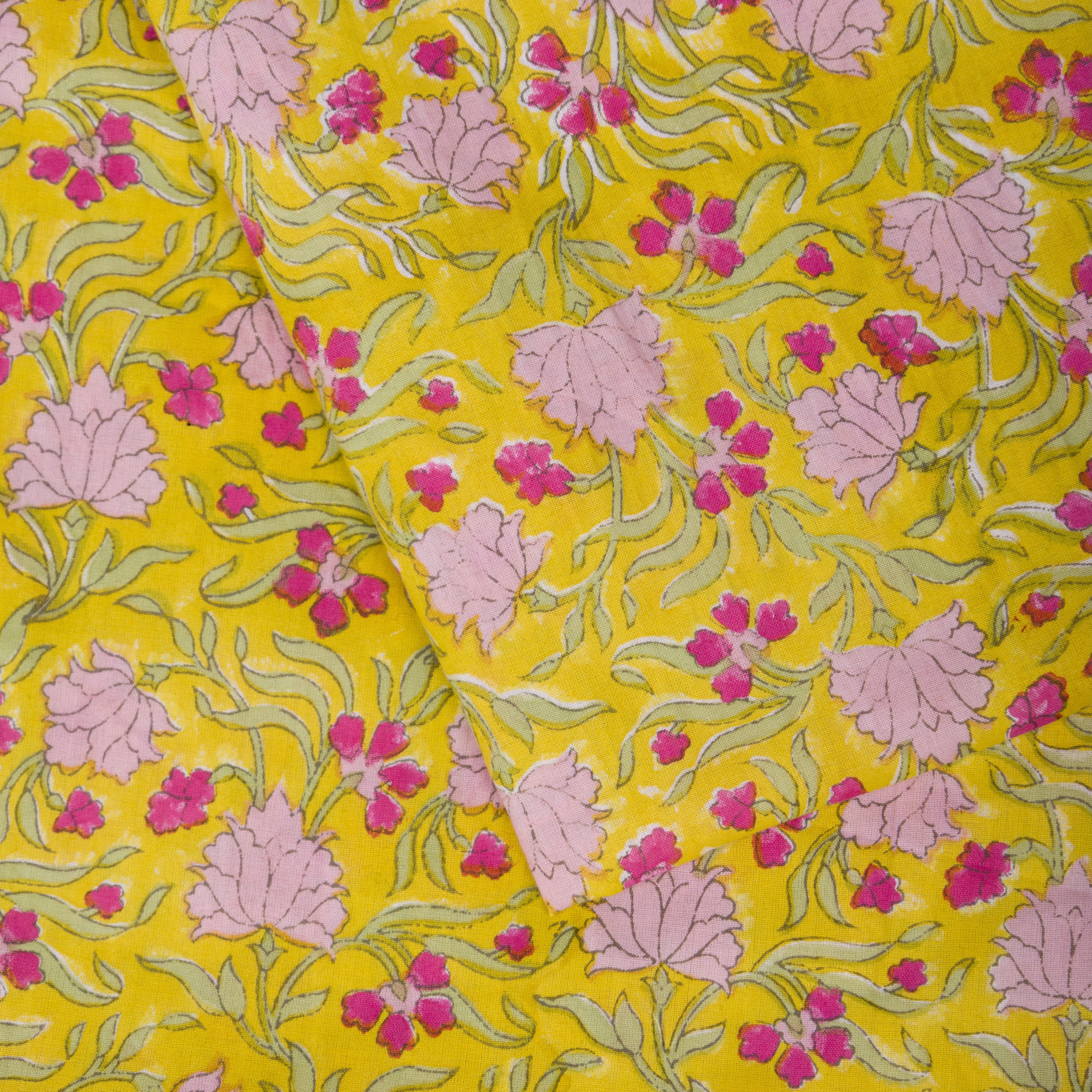 Vibrant yellow jasmine floral table cloth with a hot-pink striped border, bringing "whimsy and joy" to modern dining spaces.
