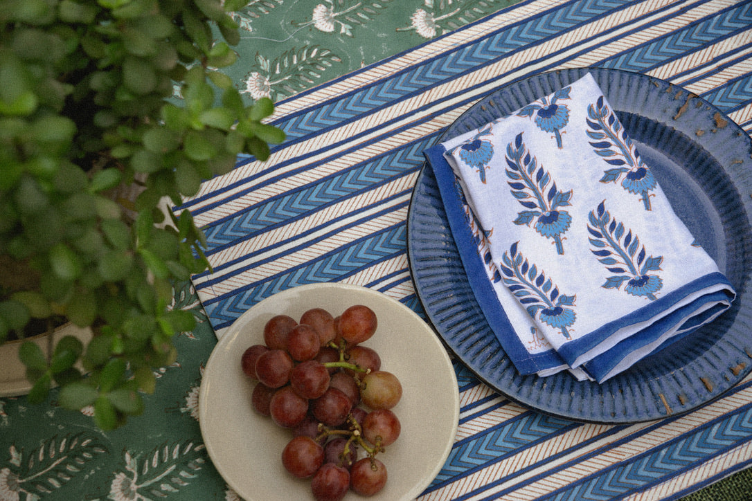 Authentic hand block-printed table setting with refined indigo patterns, adding "soul and story" to any festive dining table.