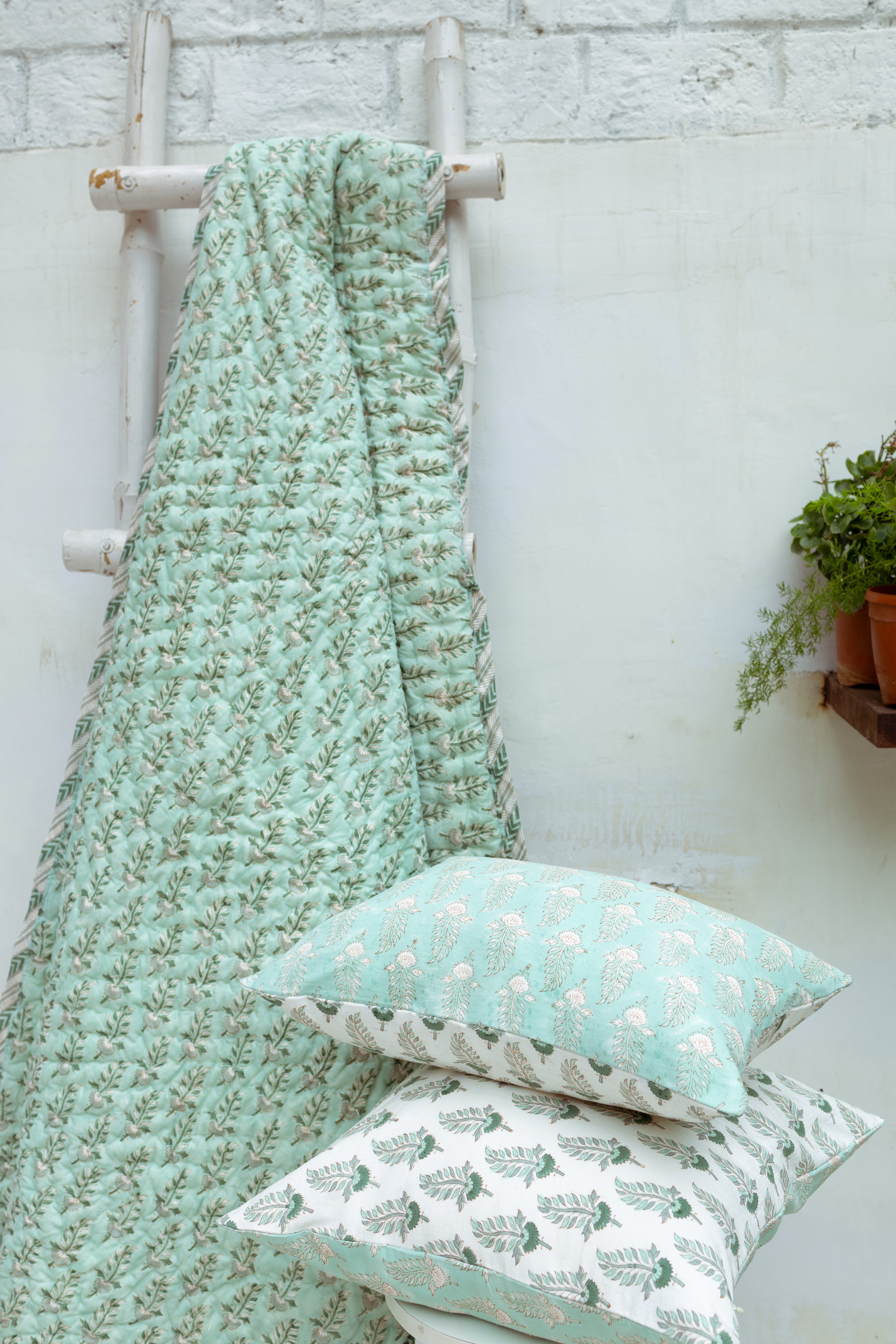 Close-up of fine hand-quilting on a Noor Collection throw, highlighting the skill of master artisans in Rajasthan.