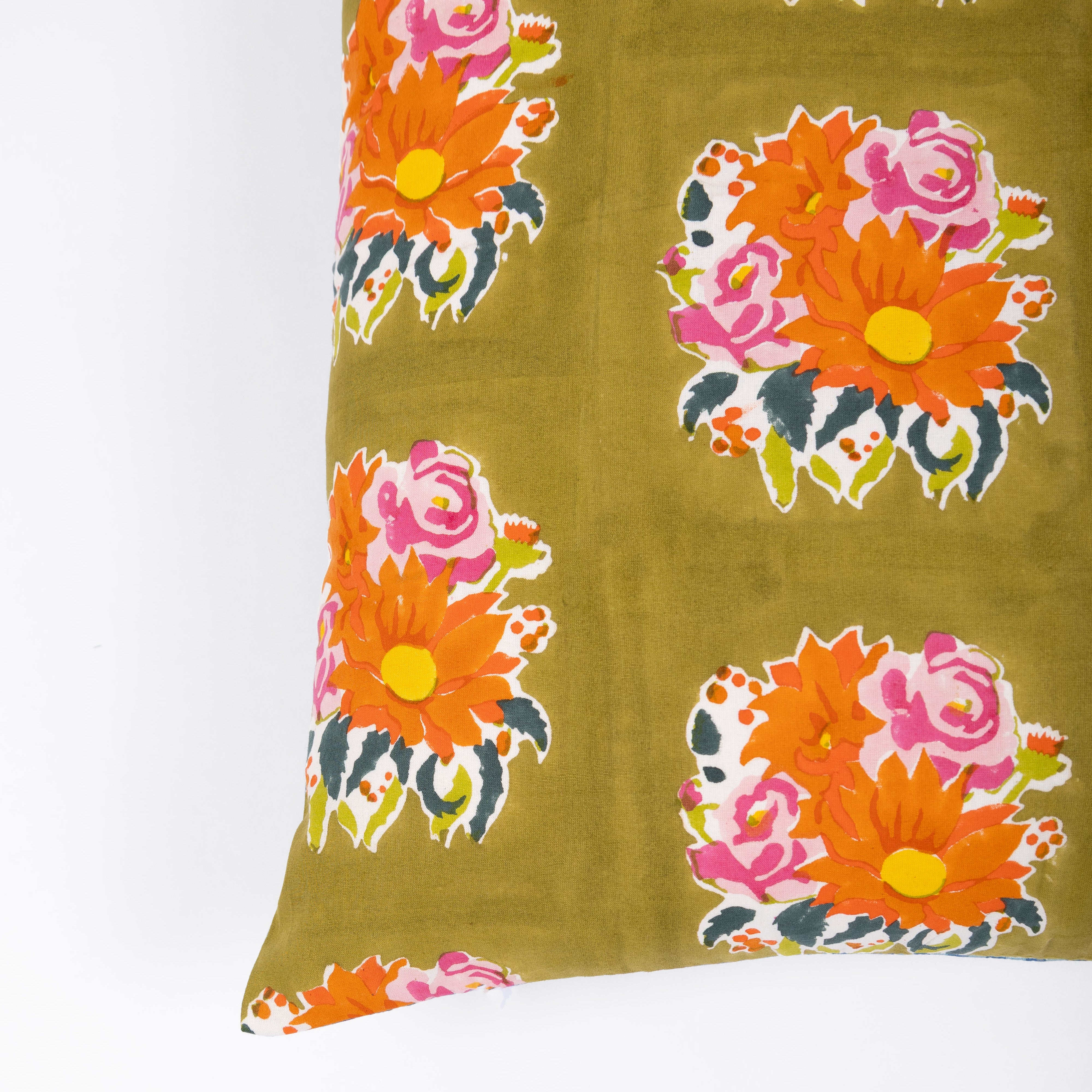 Reversible green cotton pillowcase with hand-printed florals on the front and contrasting blue stripes on the back for a layered look.