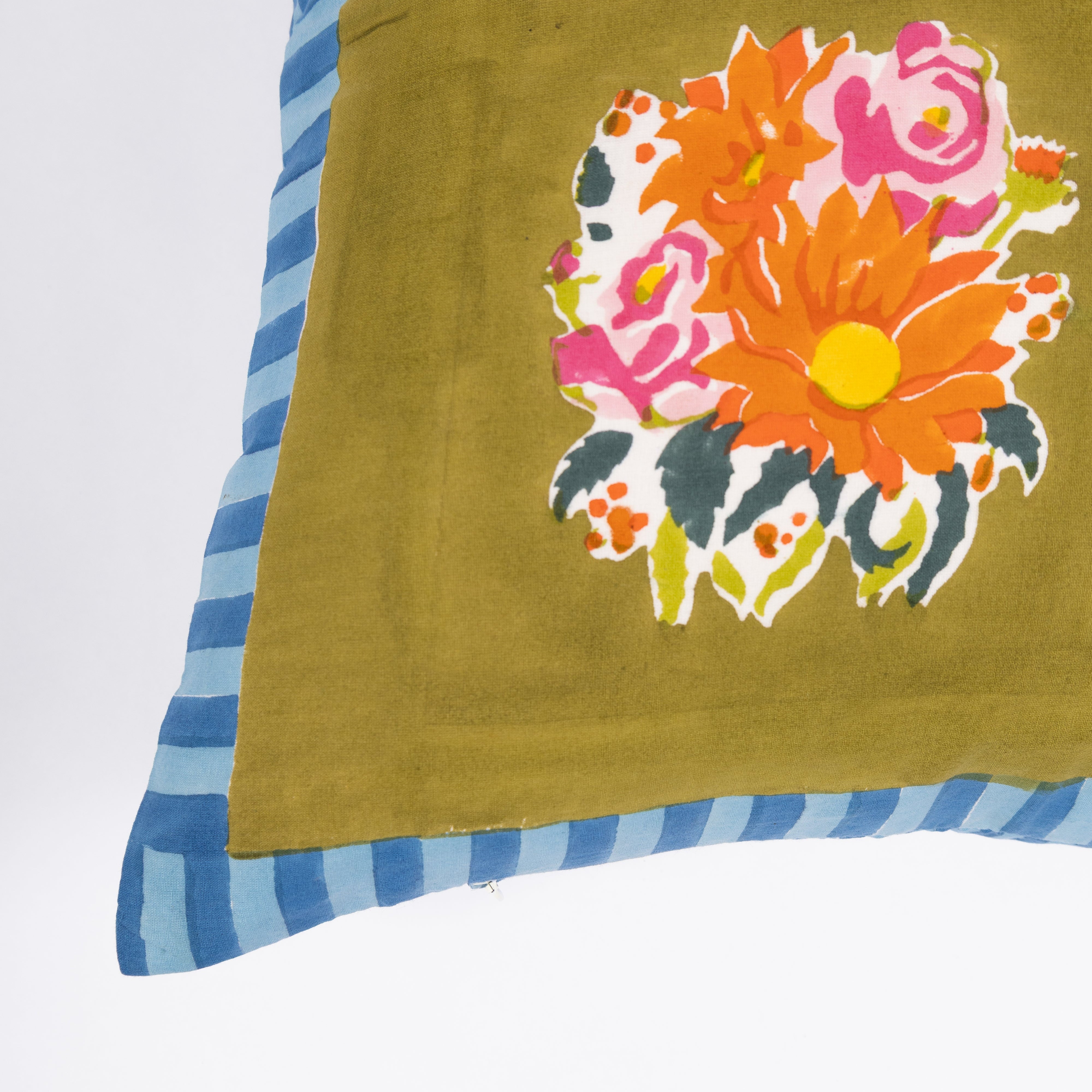 Artisan-made green pillow cover crafted from pure cotton and Azo-free dyes, reflecting a commitment to responsible production.
