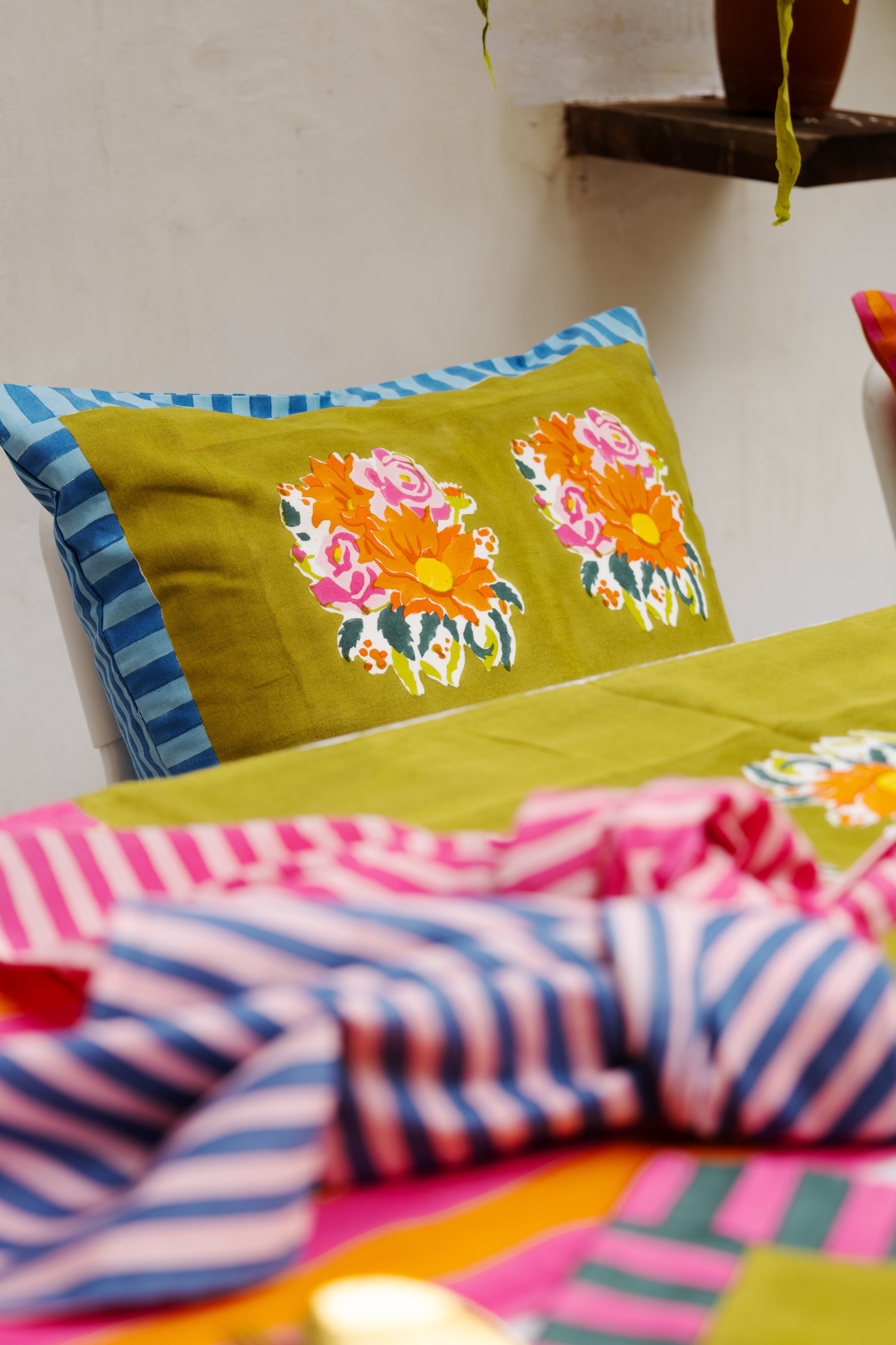 Consciously handcrafted green pillow cover designed for modern homes, supporting global handmade craftsmanship and women-led ventures.
